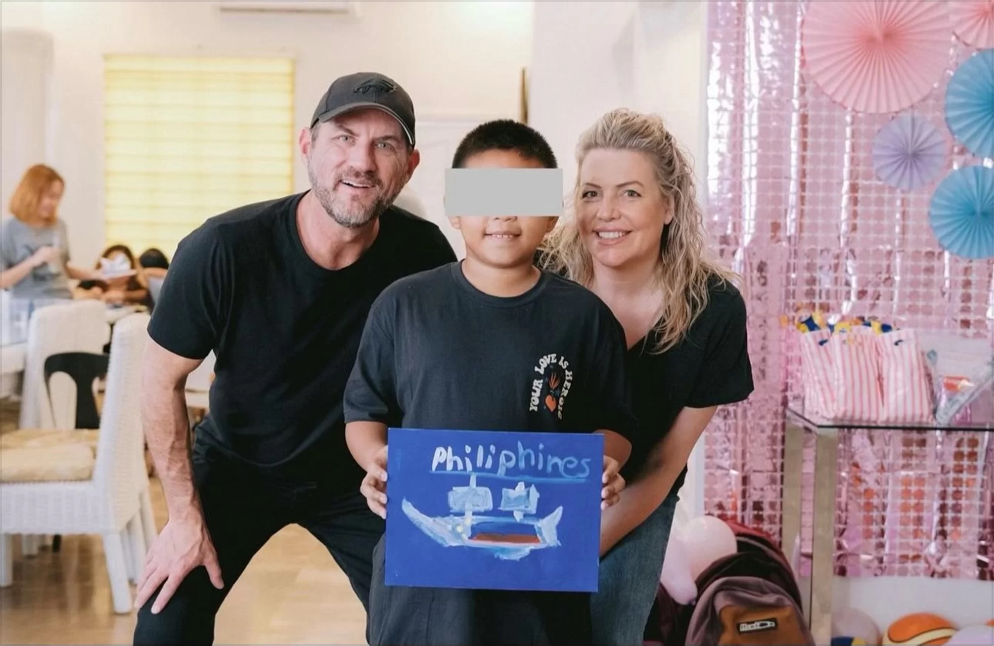 Bob and Erica with a child at Promise House